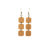 A pair of smoothed wooden drop earrings features three square pieces inlaid with bronze. Available in ash or walnut.  Each piece is handmade and unique. Placement and colors may vary and are not guaranteed but will resemble the piece shown.      1.75" long x 0.5" wide     Ear hook is bronze and nickle free.